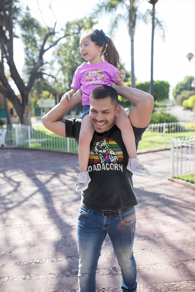 dadacorn-dad-daughter-unicorn-dad-and-daughter-wearing-t-shirts-mockup-at-a-park