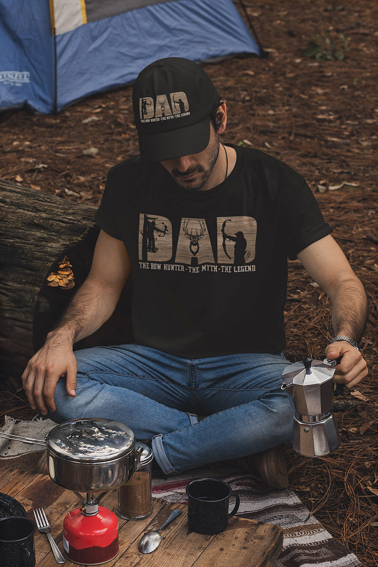 dad-the-bow-hunter-the-myth-the-legend-father's-day-t-shirt-and-dad-hat-mockup-of-a-man-making-coffee-in-a-camping-site