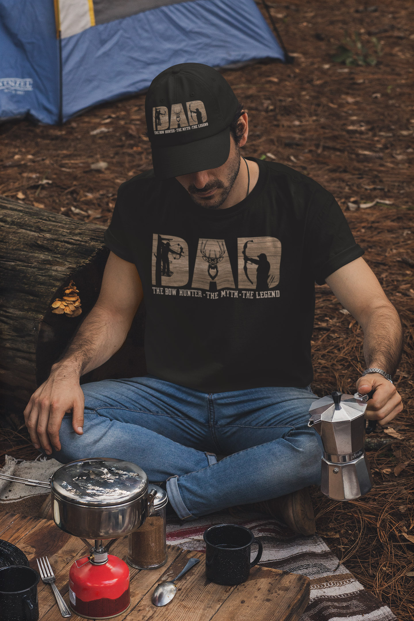 dad-the-bow-hunter-the-myth-the-legend-father's-day-t-shirt-and-dad-hat-mockup-of-a-man-making-coffee-in-a-camping-site