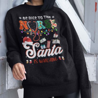 Alternative view of Be Nice To The Nurse Santa Is Watching T-Shirt - Funny Christmas Nurse Hoodie - Sweatshirt - Long Sleeve